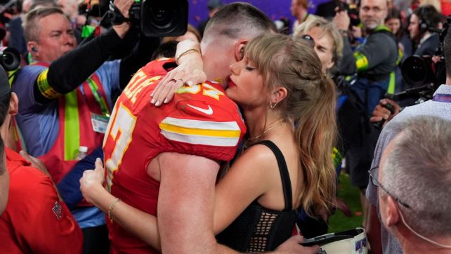 Taylor Swift and Travis Kelce hug each other